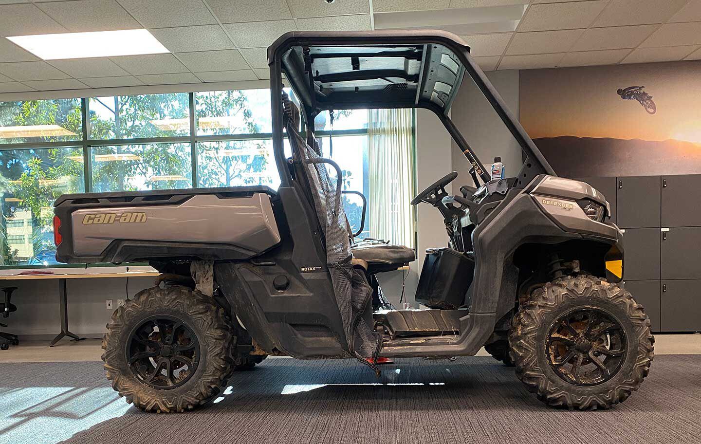 Our gloriously filthy Defender project in the <i>UTV Driver</i> West Coast office, shown here with dirty stock wheels for the XT HD10 trim.